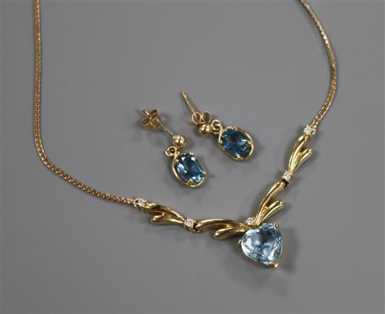 A heart-shaped aquamarine and diamond pendant on a yellow metal fine link chain and a pair of similar drop earrings.